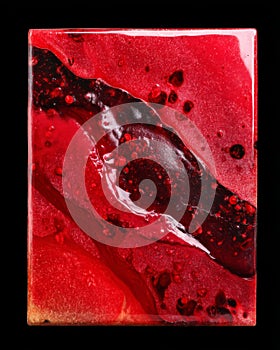 Semiprecious crimson agate tile with high gloss and lava-like inclusions photo