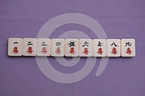 Top down view of a set of Mah Jong pieces showing all nine suited characters