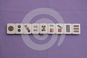 Top down view of a set of Mah Jong pieces showing all nine suited dots
