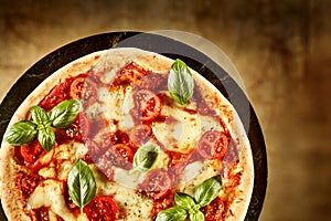 Top down view on small pizza with basil