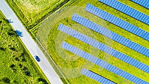 Top down view of solar panels and car on road