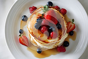 Flat Lay of Sweet Pancake Stack Garnished with Berries and Syrup