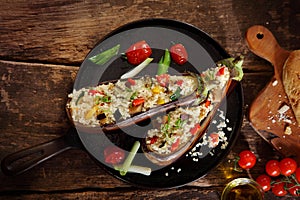 Top down view of a stuffed aubergine with couscous or quinoa