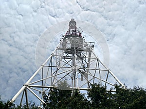 Top-down view of the telecommunication tower Overview botton on construction with down to top Sky with white clouds