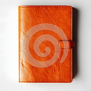 Orange leather journal with strap closure isolated on white background studio shot