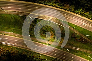 Top down view to road. Romantic night aerial photo of cars traveling. The light on the road at night in city. Background