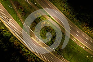 Top down view to road. Romantic night aerial photo of cars traveling. The light on the road at night in city. Background