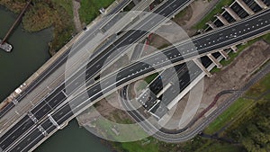 Top down view of tunnel and highway infrastructure and shipping waterway in Rotterdam, The Netherlands. Botlekbrug and