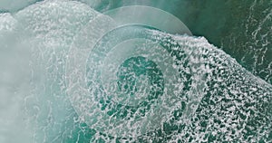 Top down view of waves. Aerial view. Ocean seen from above. Waves braking