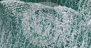 Top down view of waves. Aerial view. Ocean seen from above. Waves braking