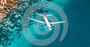 Top down view of white plane flying over blue sea, ocean, travel, vacation concept - AI generated image