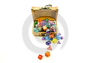 Top down of wooden chest overflowing with dice