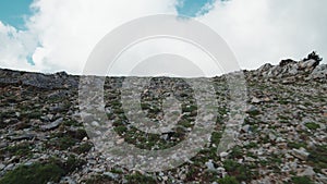 Top of a dry mountain with stones and gray soil