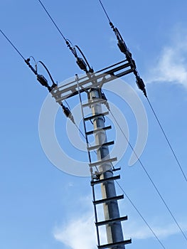 Top of the electric pylon on the backfround of the blue sky