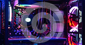 Top-end system unit for gaming computer close up. Inside of illuminated cybercafe photo