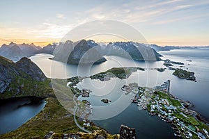 From top of the famous Reinebringen overlooking the city of Reine in Lofoten,Norway during the midnight sun.