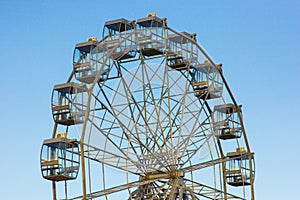 Top of a ferris wheel against a blue sky