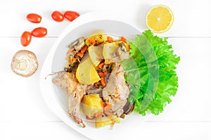 Top flat view of roasted rabbit meat on white wooden table surface