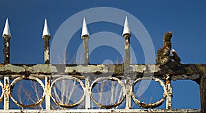 Top of the gate with spikes and an old glove. Forgotten, abandoned ghost town Skrunda, Latvia. Former Soviet army radar station