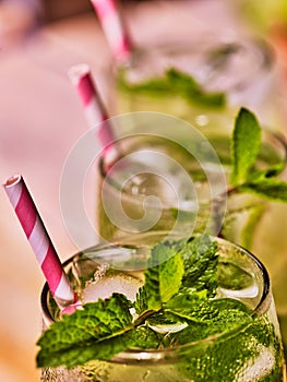 Top of glasses with straw mohito .