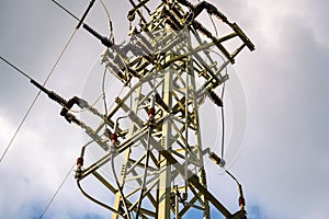Top of a high voltage pylon with many wires