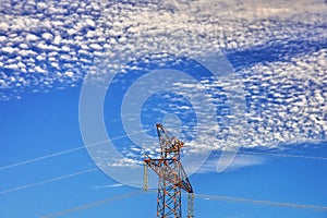 Top of high voltage pylon with nice sky with many clouds