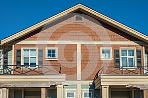 Top of a house with nice windows. Dormer and a blue sky. Real Estate Exterior Front House in a residential neighborhood