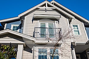 Top of a house with nice windows. Dormer and a blue sky. Real Estate Exterior Front House in a residential neighborhood