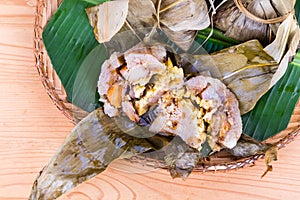 Top lay closeup on freshly steamed Chinese rice dumpling on traditional rattan tray