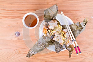 Top lay view of steamed Chinese rice dumpling or zongzi served with oriental tea
