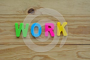 Top lay of the word Work on a wooden background