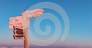 Tourist signpost mountain top Lusen covered by large ice. View of the snowy mountain peaks, view from Lusen in Bavaria in the