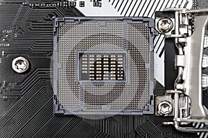 Top macro shot of empty modern LGA 1200 socket for CPU on black desktop motherboard.