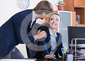 Top manager flirting with subordinate official at workplace