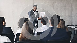 Top manager showing chart to colleagues, making presentation