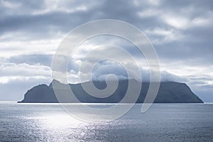 The top of the mountain of Faroe islands. A view of high peaks of mountains on a sunny day. Ocean view.  Beautiful panoramic view.