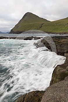 The top of the mountain of Faroe islands. A view of high peaks of mountains on a sunny day. Ocean view.  Beautiful panoramic view.