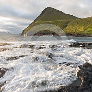 The top of the mountain of Faroe islands. A view of high peaks of mountains on a sunny day. Ocean view.  Beautiful panoramic view.