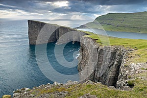 The top of the mountain of Faroe islands. A view of high peaks of mountains on a sunny day. Ocean view.  Beautiful panoramic view.