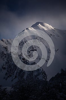 The top of the mountain in the glow of light in the evening