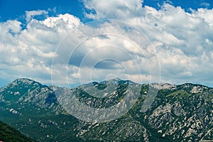 a top of mountains and cloudy sky in the Bay of Kotor during a cruise on a ship in Montenegro, a bright sunny day, mountains and