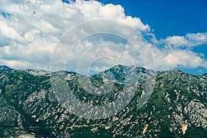 a top of mountains and cloudy sky in the Bay of Kotor during a cruise on a ship in Montenegro, a bright sunny day, mountains and