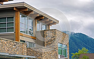 Top of nice residential building on foggy mountain background