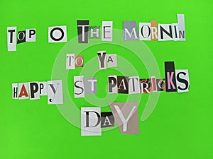 Top O the mornin to ya Happy St Patrick's day message written on scraps of magazine paper on a green background photo