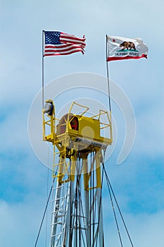 Top of Oil Rig Displaying USA and California State Flag