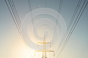 Top old electrical pillar on a background of the blue sky