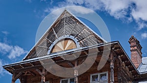 Top of old wooden house. Wooden old facade of the house. Facade of the old log house in the of wooden architecture.