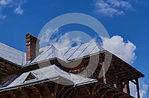 Top of old wooden house. Wooden old facade of the houÑ„se. Facade of the old log house in the of wooden architecture.