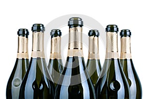 Top of open champagne bottles or sparkling wine botlles neck with golden label in rows on white background isolated close up