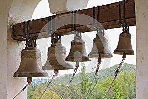 On top of Orthodox Christian monastery bell tower, Russia, Adygea, Saint Michael`s Monastery. Church bells hang in row